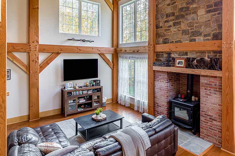 timber frame great room with wall of windows
