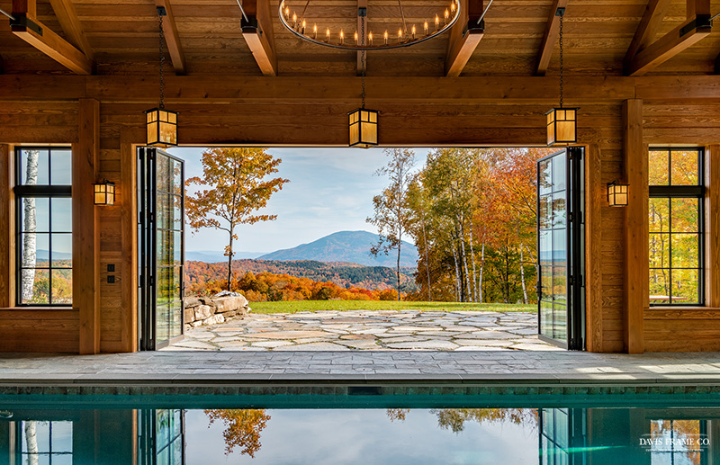 View of pool out through open glass doors